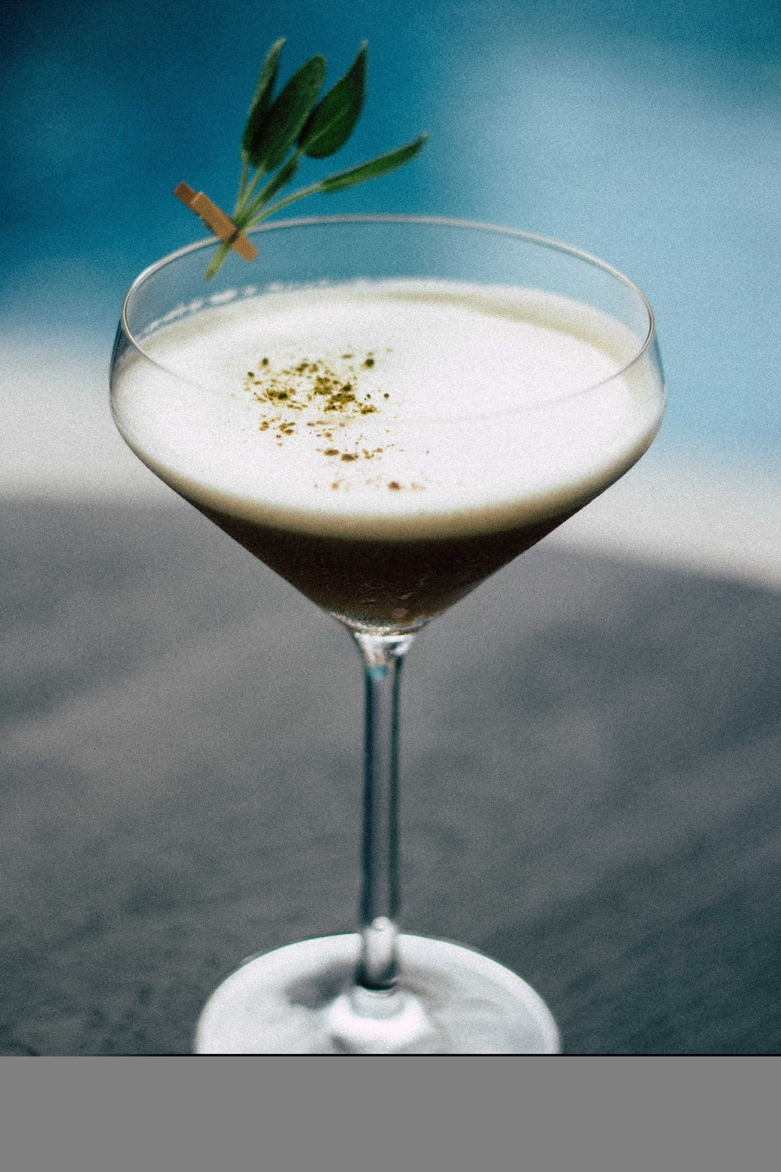 Lavender Black cocktail served in a cocktail glass with garnish