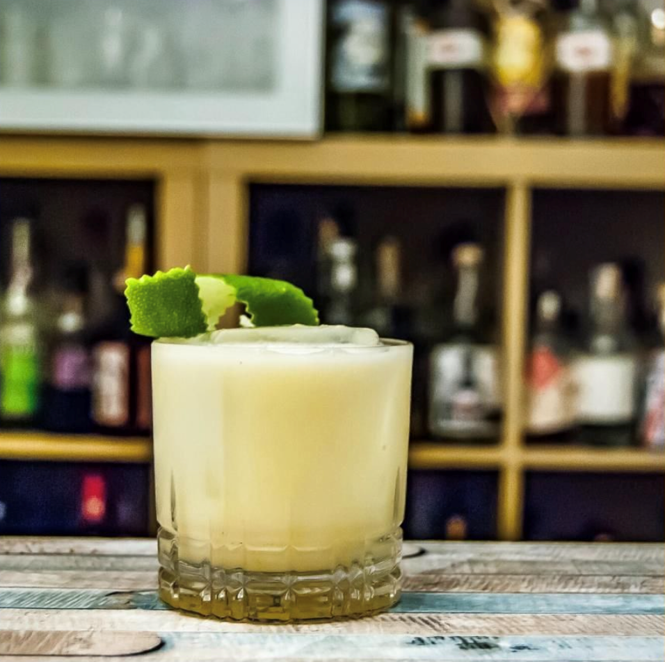 Margarita garnished with a lime. Margarita is made with tequila, limes, Yuzu Mitsu and Strathcona Orange bitters.
