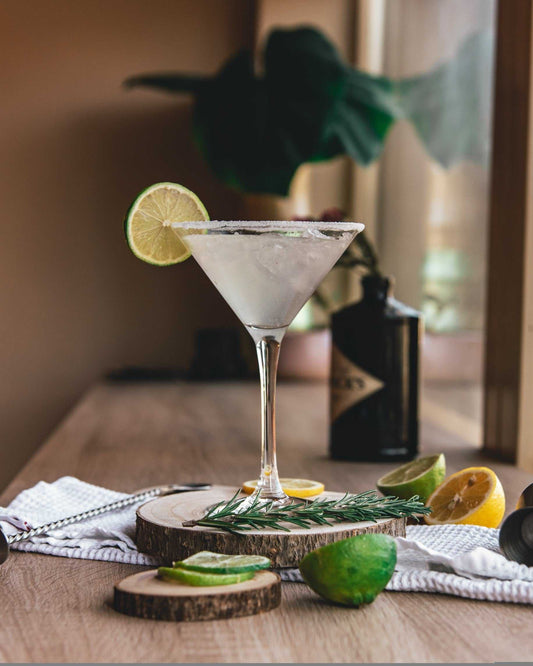Honey Lemon Martini, served with a lime wheel garnish and salted lip. Made with Hendrick's Gin