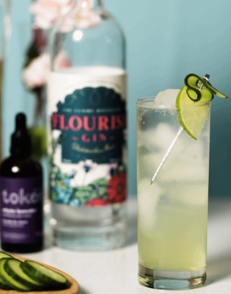 Gin mellow garnished with a cucumber, colouring is light green to clear. 