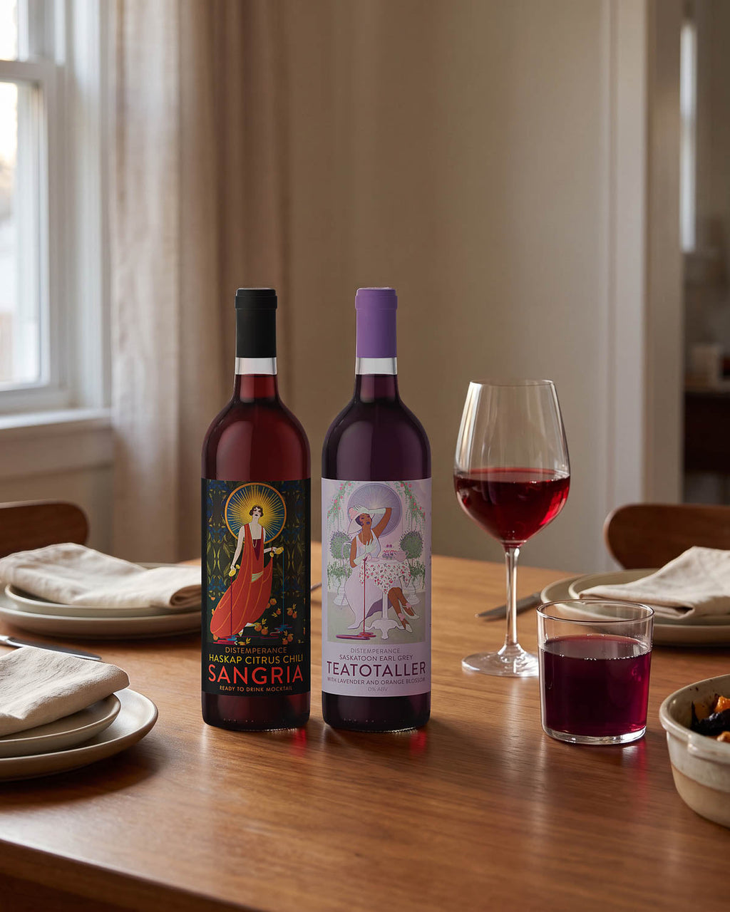 Two Token mocktail bottles on a dinner table with a glass of wine-red mocktail